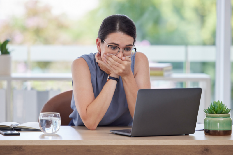 Woman in Looking at Laptop in Shock